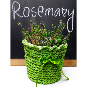 Picture example of houseplants that smell good: Bunch of rosemary in a pot with a green crocheted cover tied with a bow, displayed against a black chalkboard with the word 'rosemary' spelled out.